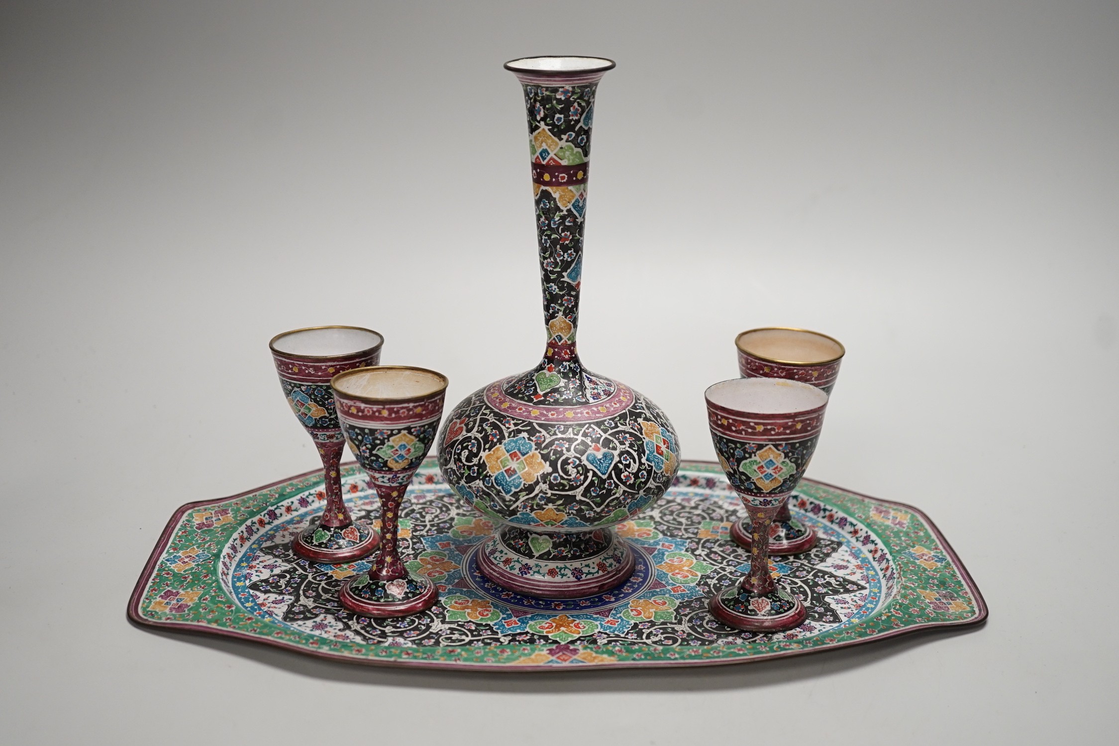 A decorative Persian enamel on copper set on stand. Tallest piece 20cm